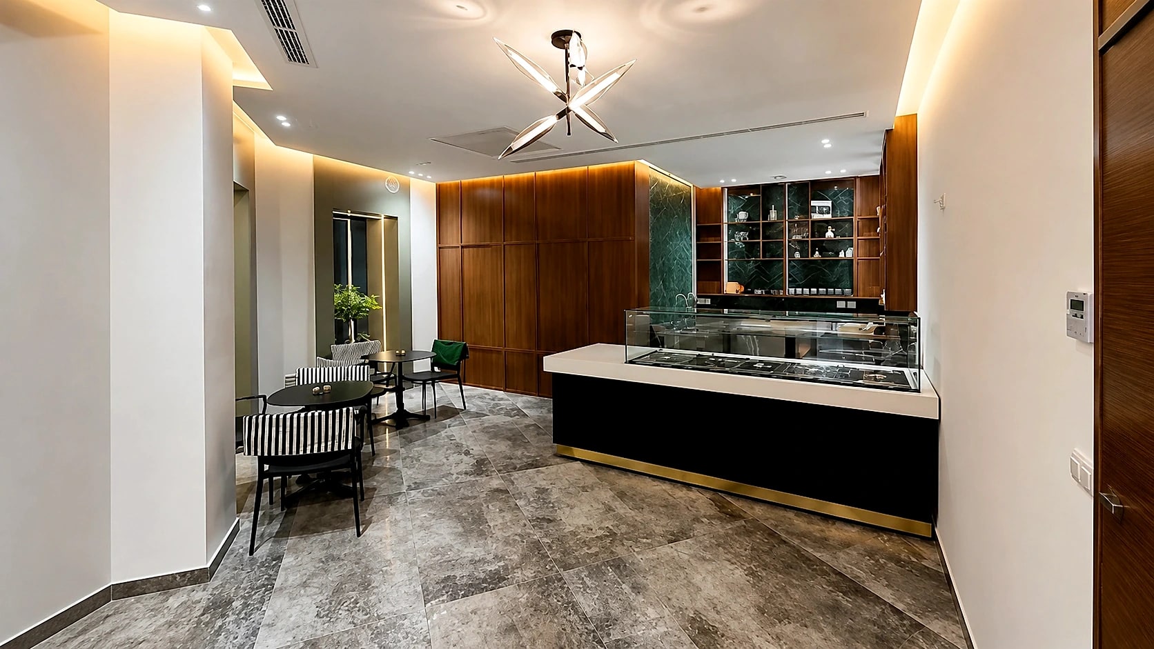 The members' lounge, with a stone and brass refreshment counter and bistro seating.